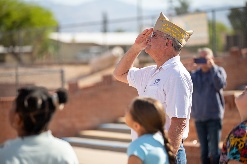 A man from the VFW salutes the flag